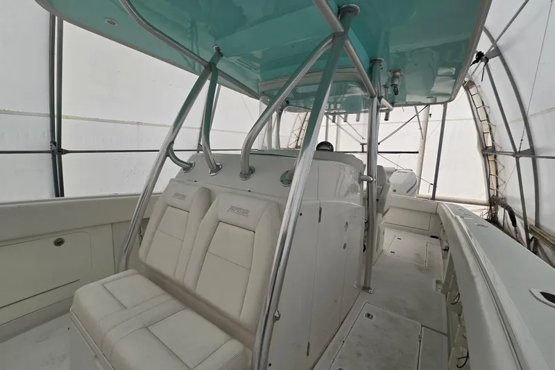  Yacht Photos Pics 2010 Jupiter 34 FS boat interior with white seating and teal canopy.