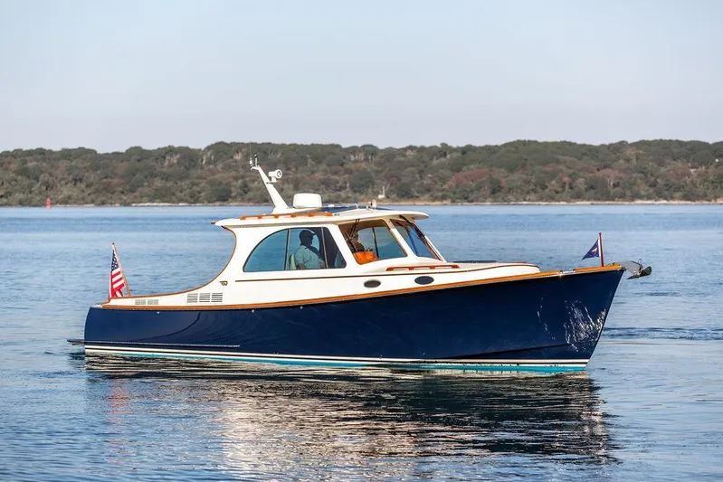 Pisces Yacht Photos Pics 2017 Hinckley Picnic Boat MKIII cruising on calm waters with scenic background.