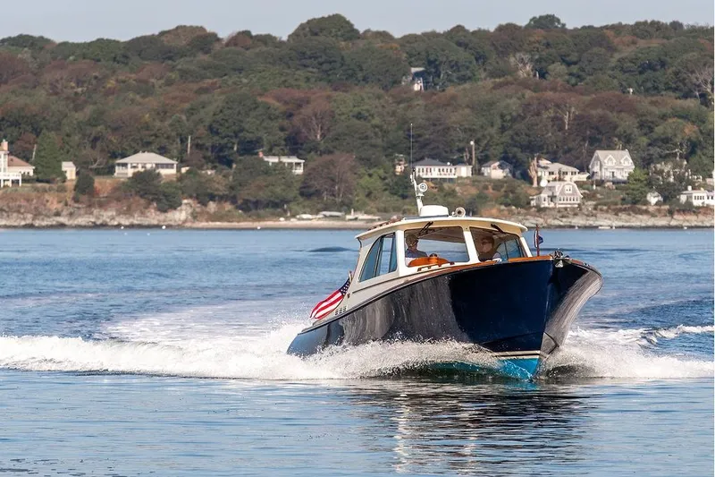 Pisces Yacht Photos Pics 2017 Hinckley Picnic Boat MKIII cruising on a scenic coastal waterway.
