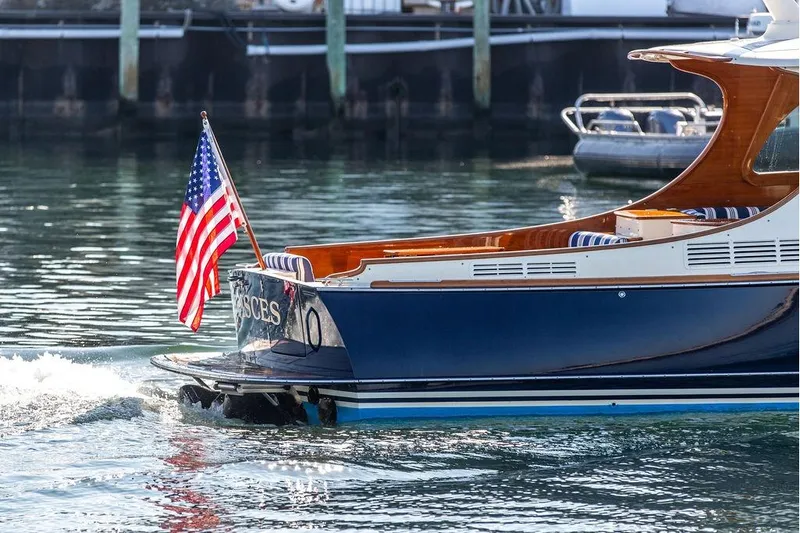 Pisces Yacht Photos Pics 2017 Hinckley Picnic Boat MKIII cruising with American flag on water.
