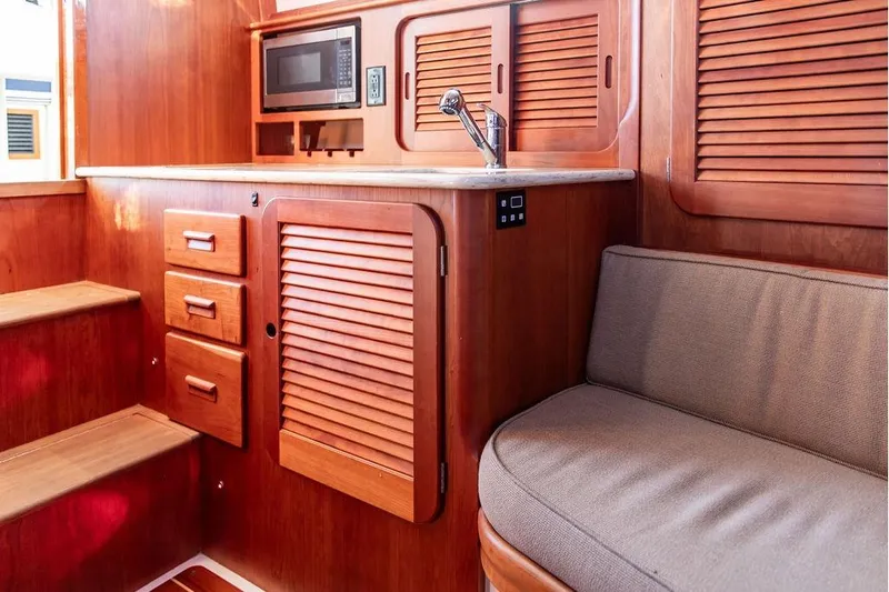 Pisces Yacht Photos Pics Interior of 2017 Hinckley Picnic Boat MKIII with wooden cabinetry and seating.
