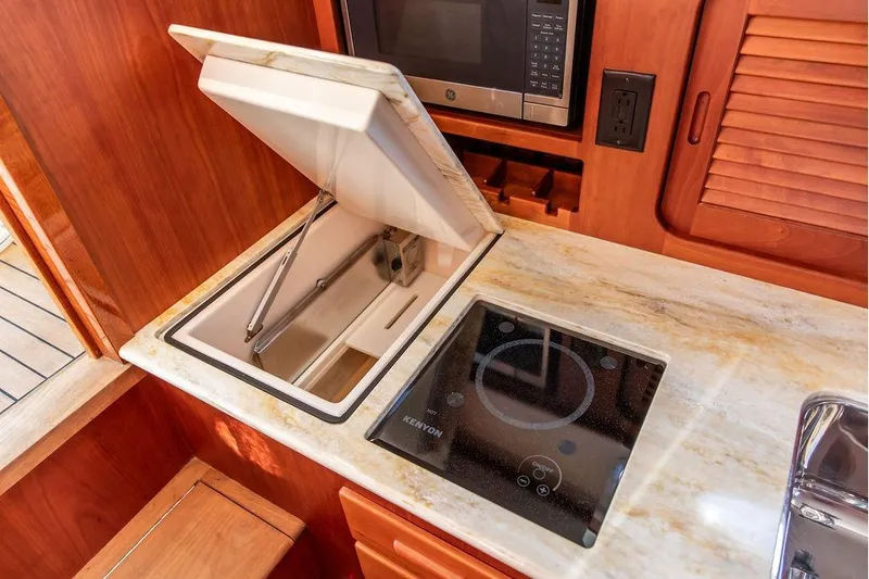 Pisces Yacht Photos Pics 2017 Hinckley Picnic Boat MKIII galley with stove, microwave, and storage.