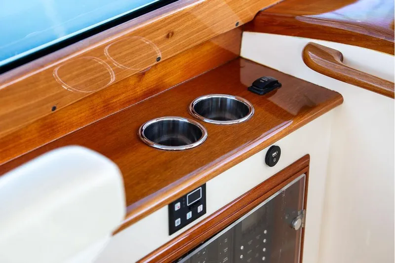 Pisces Yacht Photos Pics 2017 Hinckley Picnic Boat MKIII interior with wooden finish and cup holders.