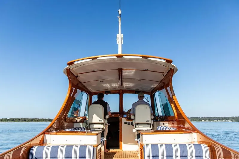 Pisces Yacht Photos Pics 2017 Hinckley Picnic Boat MKIII cruising on calm waters under clear blue sky.