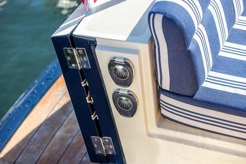Pisces Yacht Photos Pics 2017 Hinckley Picnic Boat MKIII with striped seating and polished hardware details.