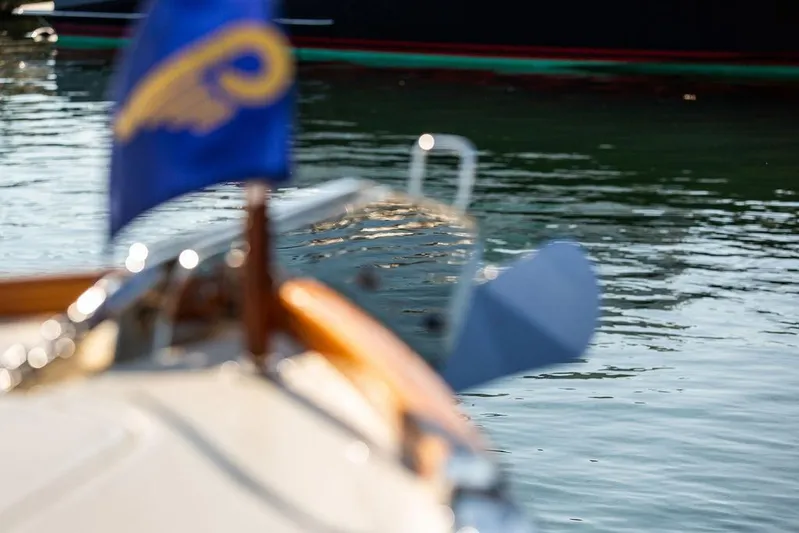 Pisces Yacht Photos Pics 2017 Hinckley Picnic Boat MKIII on water, with blurred flag in foreground.