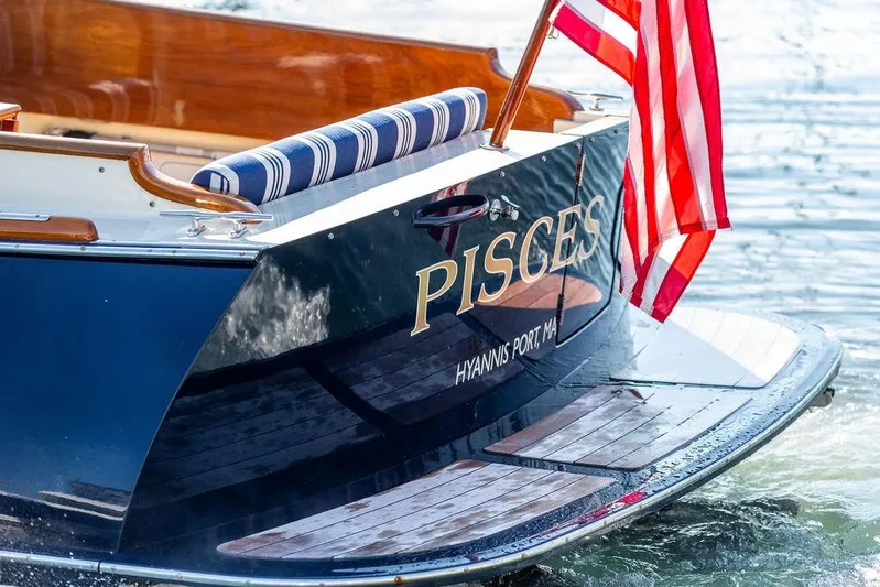 Pisces Yacht Photos Pics Hinckley Picnic Boat MKIII 2017 with American flag, named "Pisces," docked at Hyannis Port.