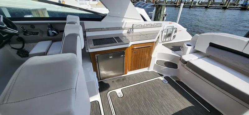  Yacht Photos Pics 2018 Four Winns H350 OB boat interior with seating, kitchenette, and water view.