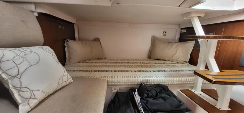  Yacht Photos Pics Cozy cabin interior of 2018 Four Winns H350 OB boat with cushions and wooden accents.