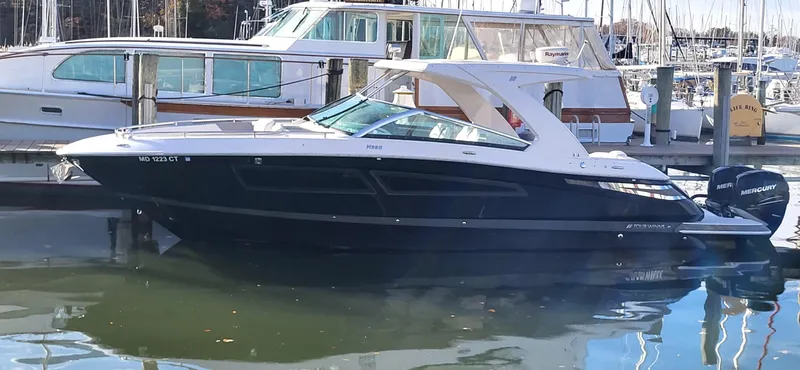  Yacht Photos Pics 2018 Four Winns H350 OB boat docked in a marina, featuring sleek design and twin outboard engines.