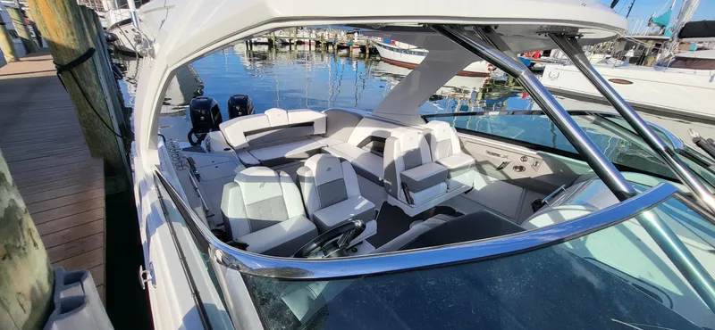 Yacht Photos Pics 2018 Four Winns H350 OB boat docked, showcasing spacious seating and sleek design.