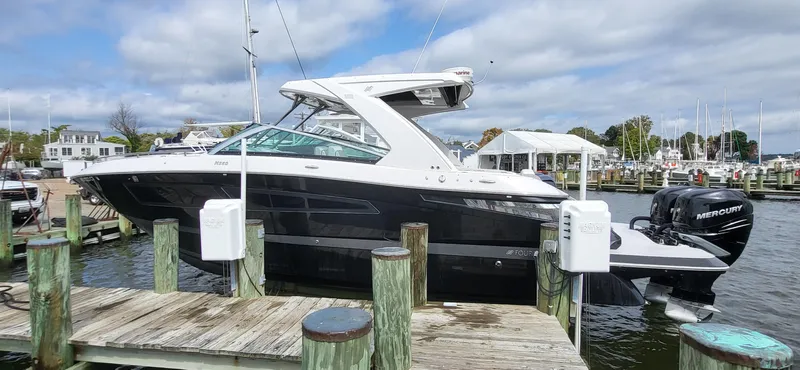  Yacht Photos Pics 2018 Four Winns H350 OB boat docked at a marina with Mercury outboard engines.