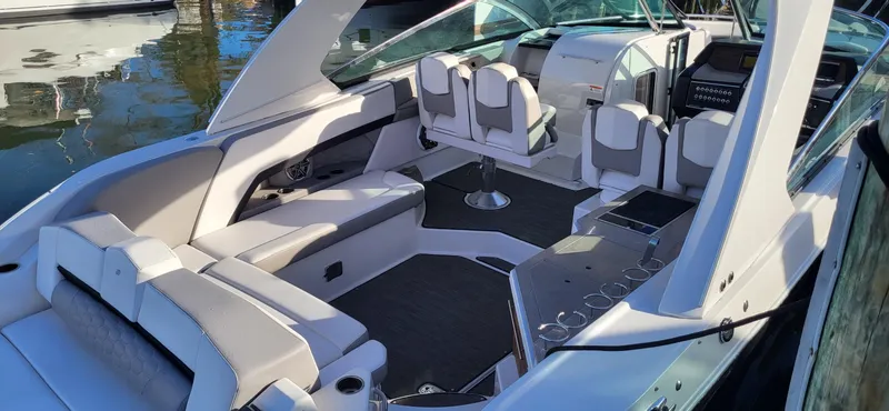  Yacht Photos Pics 2018 Four Winns H350 OB boat interior with seating and helm, docked on water.