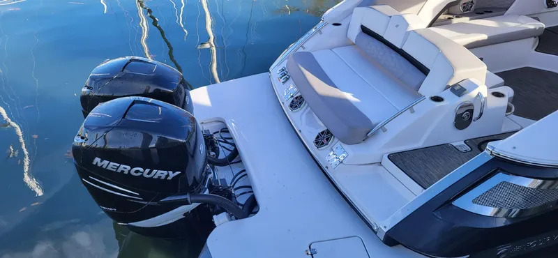  Yacht Photos Pics 2018 Four Winns H350 OB boat with dual Mercury outboard engines, docked on calm water.