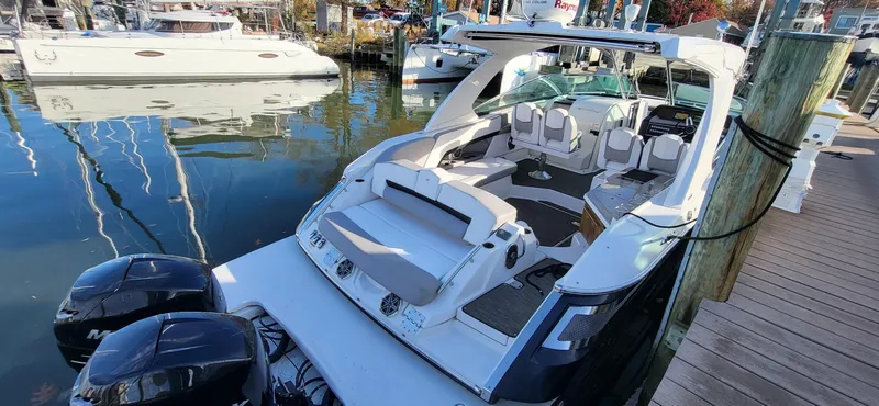  Yacht Photos Pics 2018 Four Winns H350 OB boat docked, featuring spacious seating and dual outboard engines.
