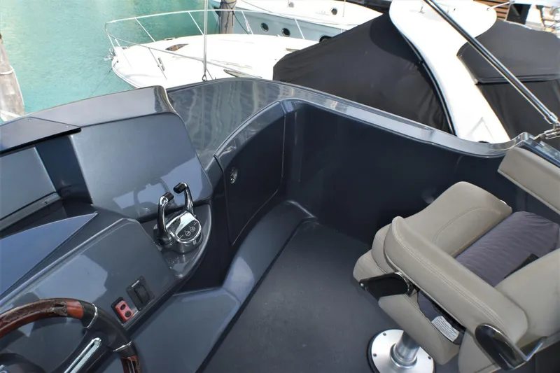 Yacht Photos Pics 2019 Silverton 41 Sport Bridge helm station with leather captain's chair and control panel.