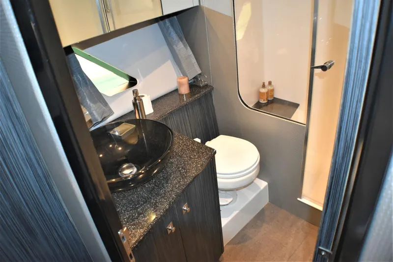  Yacht Photos Pics 2019 Silverton 41 Sport Bridge bathroom with modern sink, toilet, and shower.