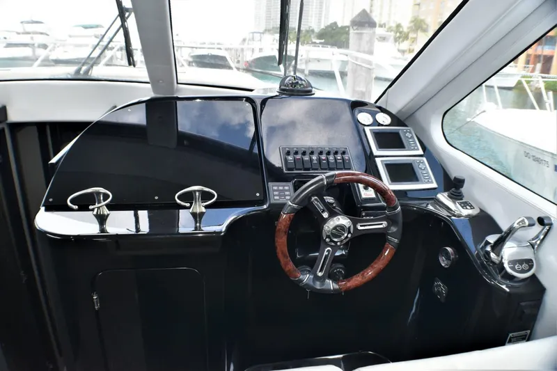  Yacht Photos Pics Helm station of 2019 Silverton 41 Sport Bridge with modern controls and wooden steering wheel.