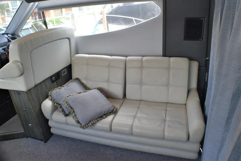  Yacht Photos Pics Luxurious interior of 2019 Silverton 41 Sport Bridge with leather seating and decorative pillows.