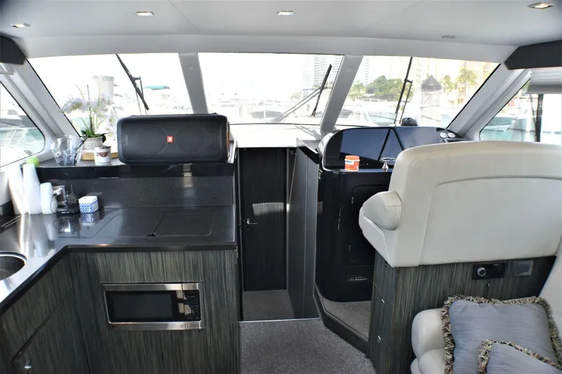  Yacht Photos Pics Interior of 2019 Silverton 41 Sport Bridge yacht with modern kitchen and helm station.