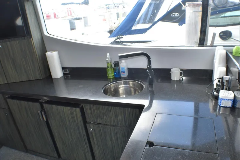  Yacht Photos Pics Modern kitchen area in 2019 Silverton 41 Sport Bridge yacht with sink and countertop.