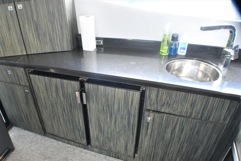  Yacht Photos Pics Modern kitchen area in 2019 Silverton 41 Sport Bridge yacht with sink and storage cabinets.