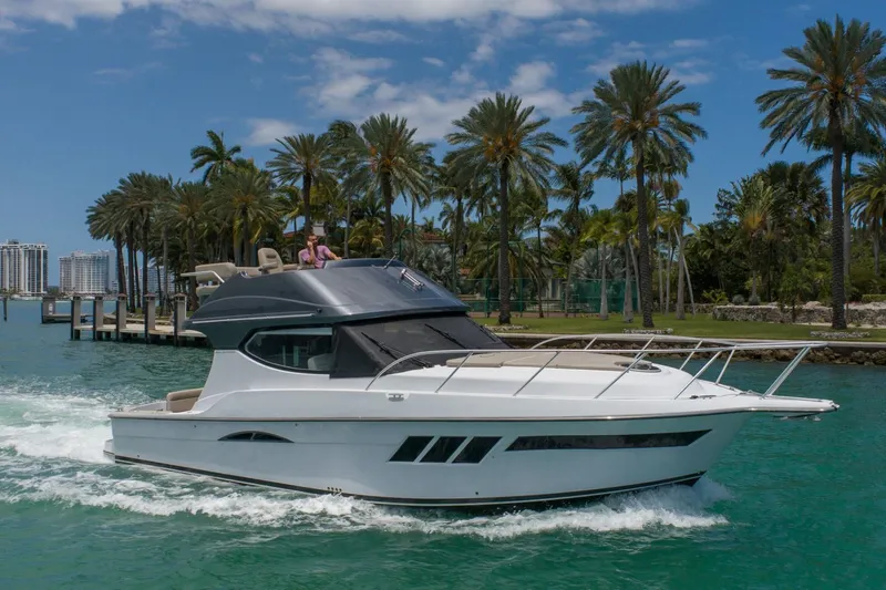  Yacht Photos Pics 2019 Silverton 41 Sport Bridge yacht cruising near palm trees.