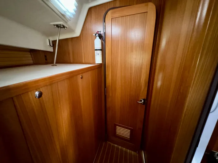 Amelie Yacht Photos Pics Interior of 2018 Catalina 425 sailboat with wooden cabinetry and fire extinguisher.