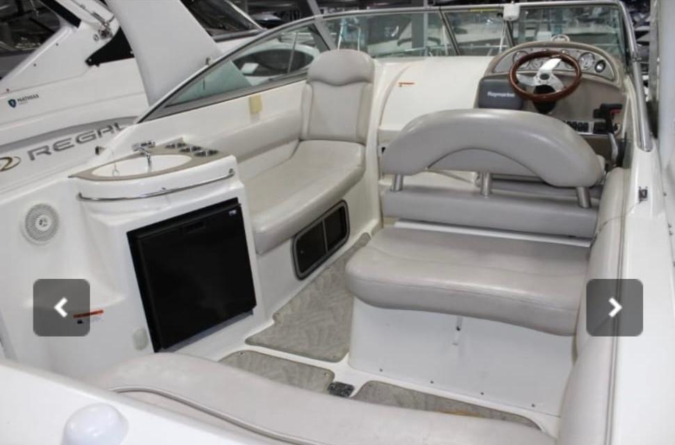 2007 Larson Cabrio 274 boat interior with seating and steering wheel.