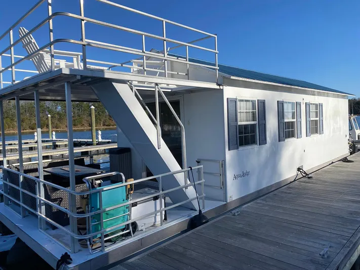  Yacht Photos Pics 2018 Catamaran Cruisers 42 Aqualodge houseboat docked, featuring upper deck and white exterior.