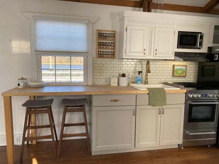  Yacht Photos Pics Cozy kitchen in 2018 Catamaran Cruisers 42 Aqualodge with white cabinets and wooden countertop.