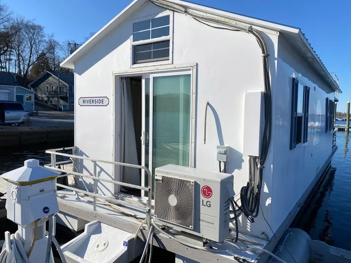  Yacht Photos Pics 2018 Catamaran Cruisers 42 Aqualodge houseboat docked, featuring sliding glass door and LG air conditioning unit.