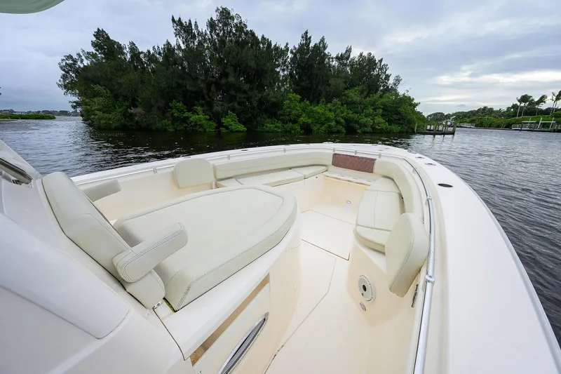 Conched Out Yacht Photos Pics 2020 Cobia 350 CC boat interior with plush seating on a calm waterway.