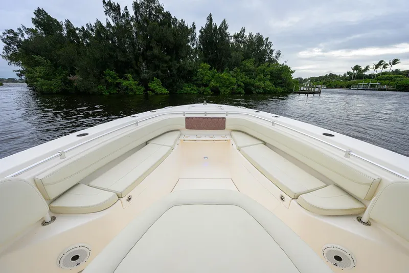 Conched Out Yacht Photos Pics 2020 Cobia 350 CC boat interior with spacious seating, near lush greenery and calm waters.