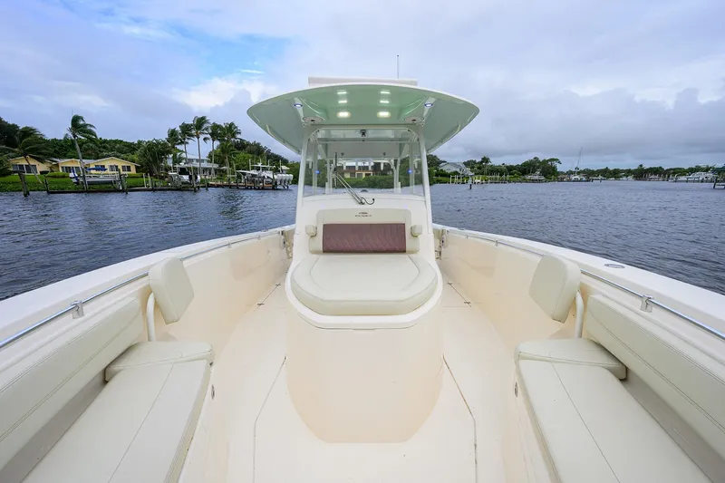 Conched Out Yacht Photos Pics 2020 Cobia 350 CC boat on calm water, featuring spacious seating and modern design.