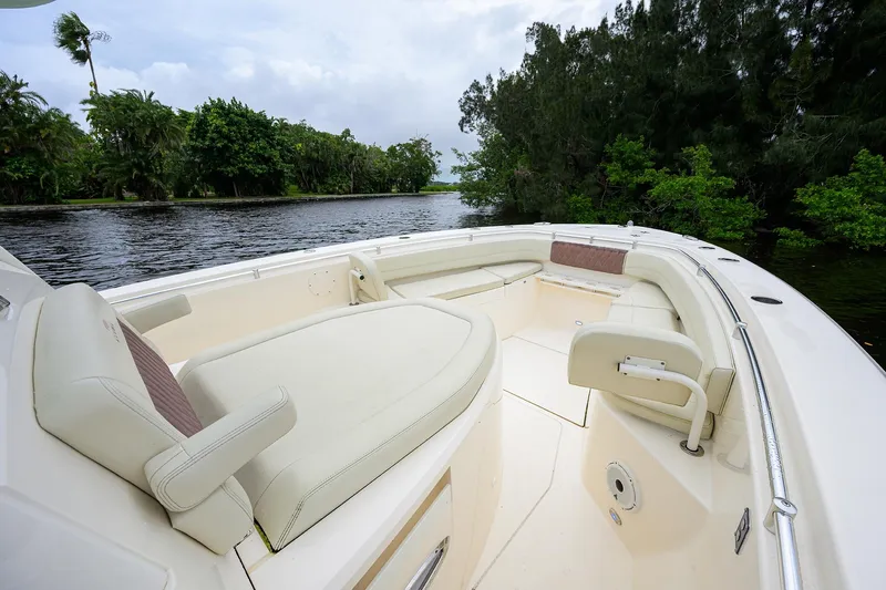 Conched Out Yacht Photos Pics 2020 Cobia 350 CC boat interior with spacious seating, surrounded by lush greenery and water.