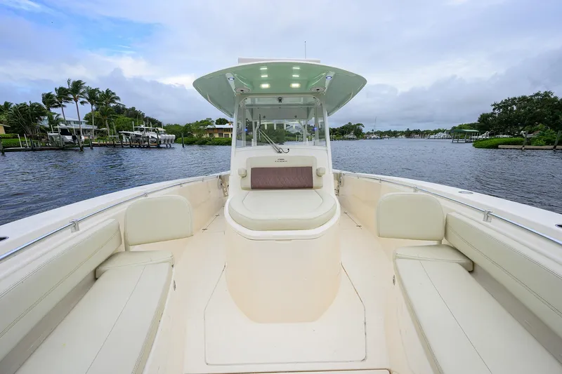 Conched Out Yacht Photos Pics 2020 Cobia 350 CC boat on a serene waterway with lush greenery.