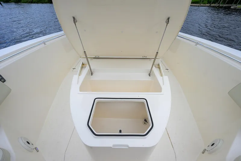 Conched Out Yacht Photos Pics 2020 Cobia 350 CC boat storage compartment open on deck by water.