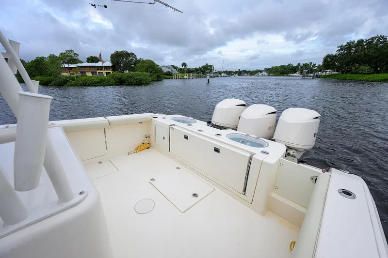 Conched Out Yacht Photos Pics 2020 Cobia 350 CC boat with triple engines on a calm river.