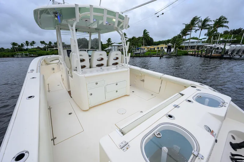 Conched Out Yacht Photos Pics 2020 Cobia 350 CC boat with spacious deck and seating, docked by waterfront homes.