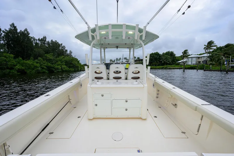 Conched Out Yacht Photos Pics 2020 Cobia 350 CC boat interior with seating, on a calm waterway.