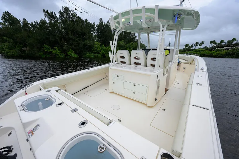 Conched Out Yacht Photos Pics 2020 Cobia 350 CC boat interior with seating and storage, docked on a calm waterway.