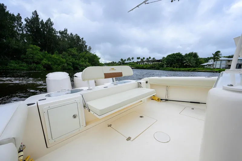 Conched Out Yacht Photos Pics 2020 Cobia 350 CC boat interior with seating, on a scenic river backdrop.