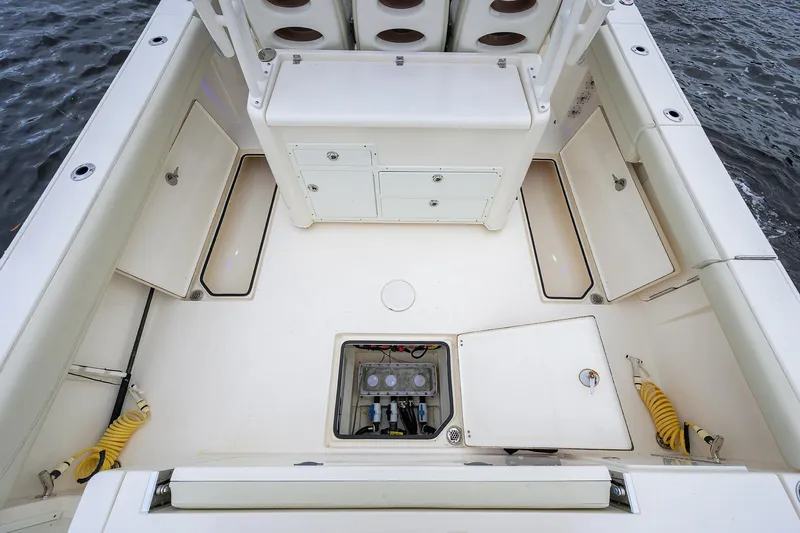 Conched Out Yacht Photos Pics 2020 Cobia 350 CC boat deck with storage compartments and seating, on water.