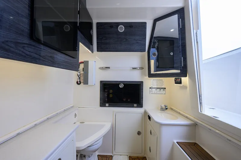 Conched Out Yacht Photos Pics 2020 Cobia 350 CC boat interior with modern bathroom amenities and sleek design.