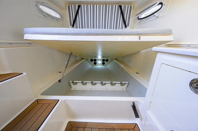 Conched Out Yacht Photos Pics 2020 Cobia 350 CC cabin interior with storage and seating area.