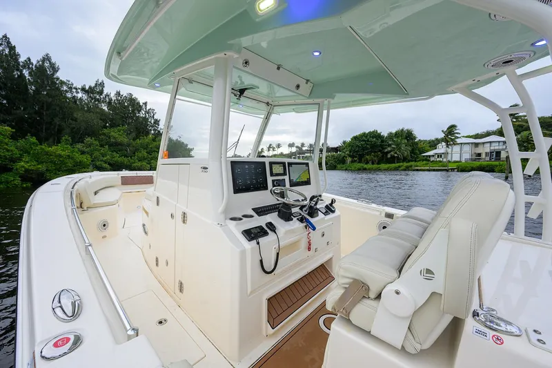 Conched Out Yacht Photos Pics 2020 Cobia 350 CC boat interior with modern helm and seating on a scenic waterway.