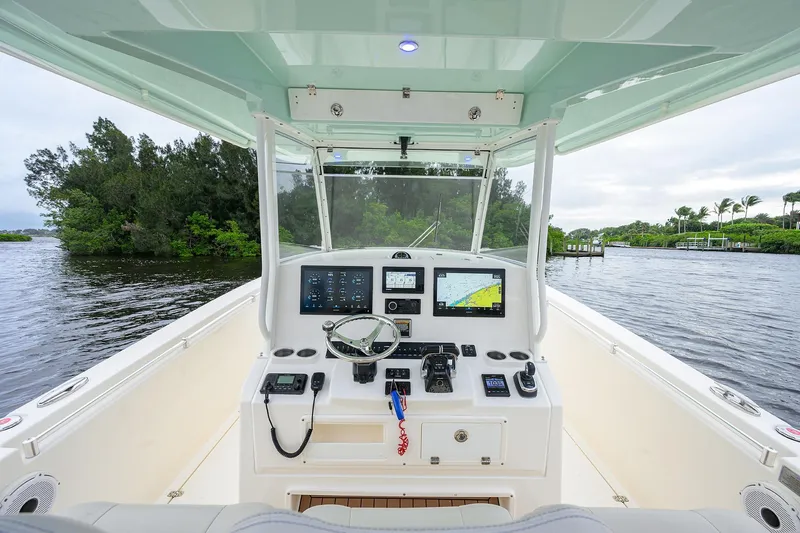 Conched Out Yacht Photos Pics 2020 Cobia 350 CC boat cockpit with advanced navigation systems on a scenic waterway.