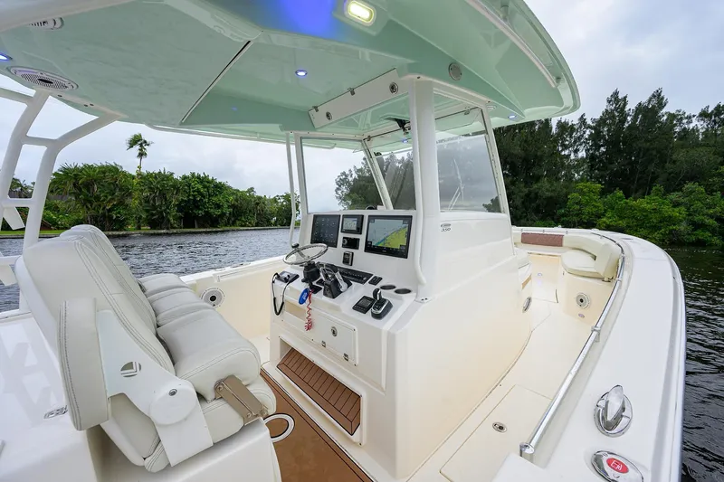 Conched Out Yacht Photos Pics 2020 Cobia 350 CC boat cockpit with modern navigation system and comfortable seating.