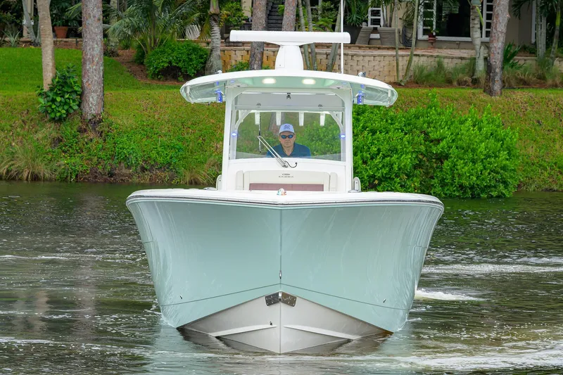 Conched Out Yacht Photos Pics 2020 Cobia 350 CC boat cruising on a scenic waterway.